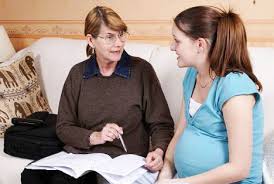 pregnant lady talking to midwife